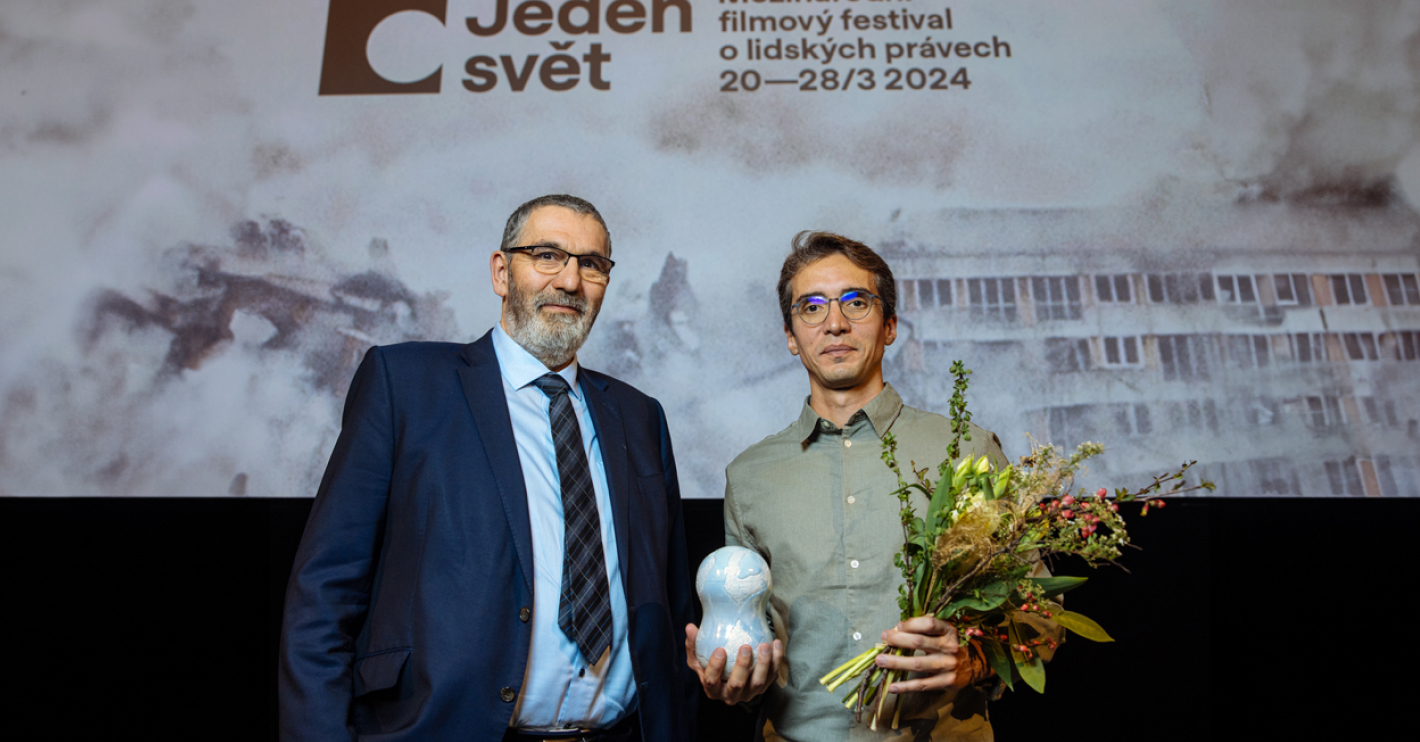 Igor Blaževič a režisér Caiao Cavechini na pódiu drží cenu a kytici.